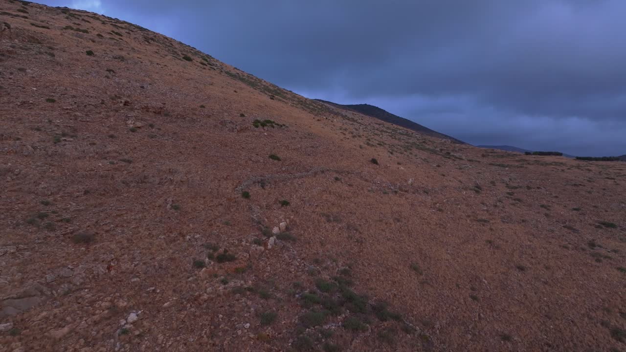 Aerial view of sunrise light on rugged hills and cloudy sky, Lagia Greece