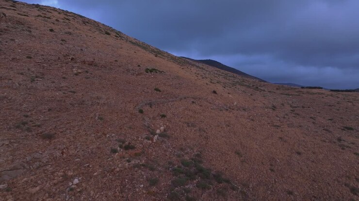 Aerial view of sunrise light on rugged hills and cloudy sky, Lagia Greece