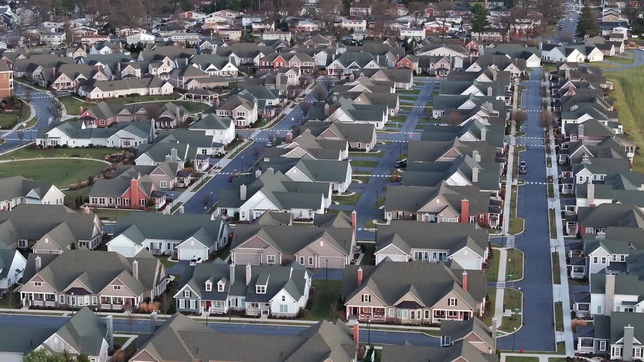 New Modern American Neighborhood with similar semi-detached building in America. Sunset time in winter season. Aerial landing wide shot. Luxury and noble real estates in Suburb of city in PA, USA.
