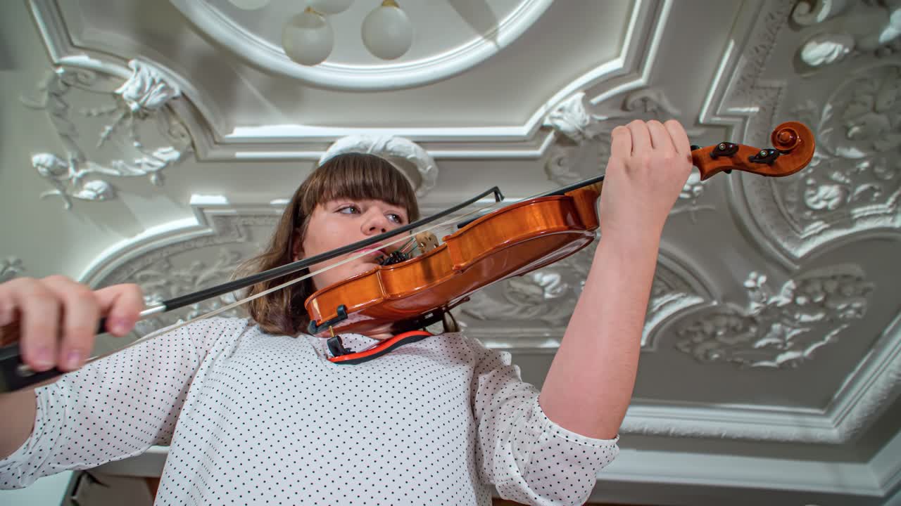 women violinist play at the Dvorec Bukovje, Slovenj Grade. Close up , up shot