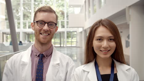 portrait of male and female doctor in hospital reception