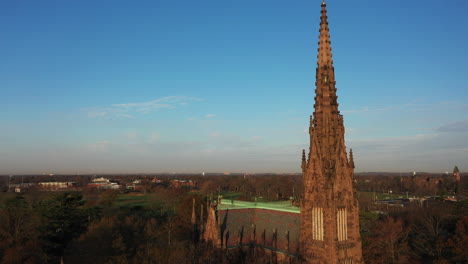 an aerial shot of a beautiful cathedral with a tall steeple, taken at sunrise