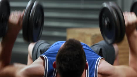 fit man lifting dumbbells