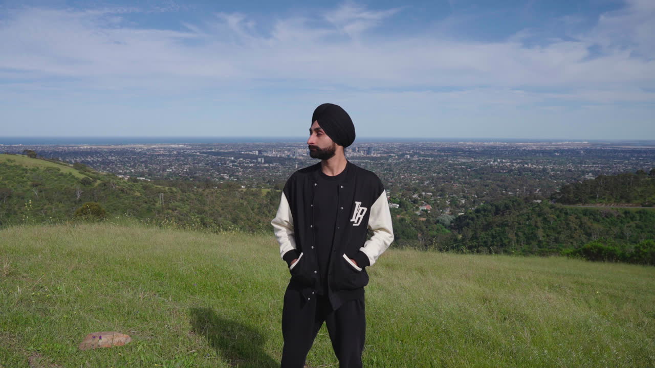Handsome Indian Sikh Man Standing In The Meadow - push in