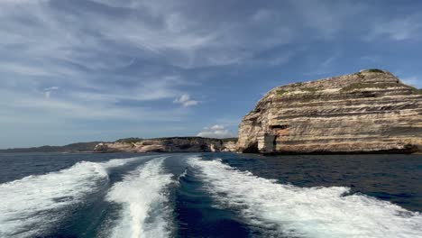 stern of sailboat perspective sailing away from bonifacio harbour on corsica island in france