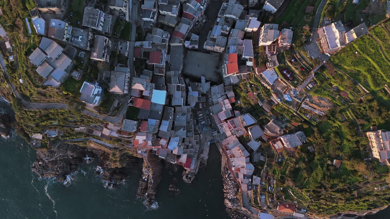 Coastal village of Riomaggiore with tight-knit houses on hills and stunning ocean views