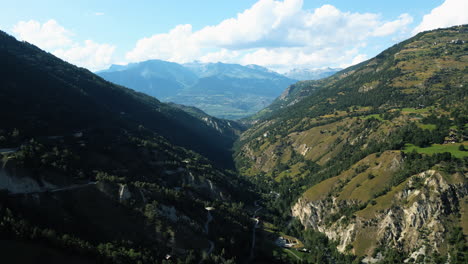 aerial: val d'herens valley near fairy chimney rock formations of euseigne during the day in canton of valais, switzerland, establishing drone shot