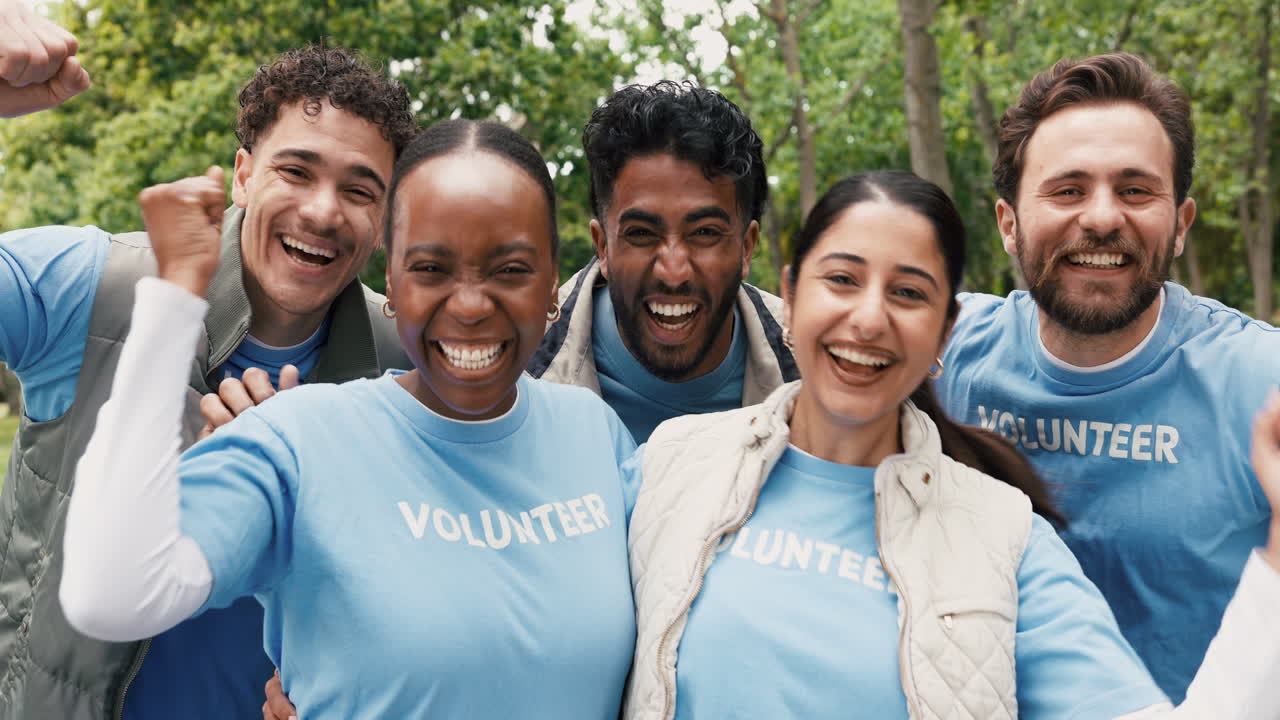 Happy Diverse Group of Volunteers Cheering and Smiling in a Park