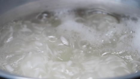 boiling rice in a pot