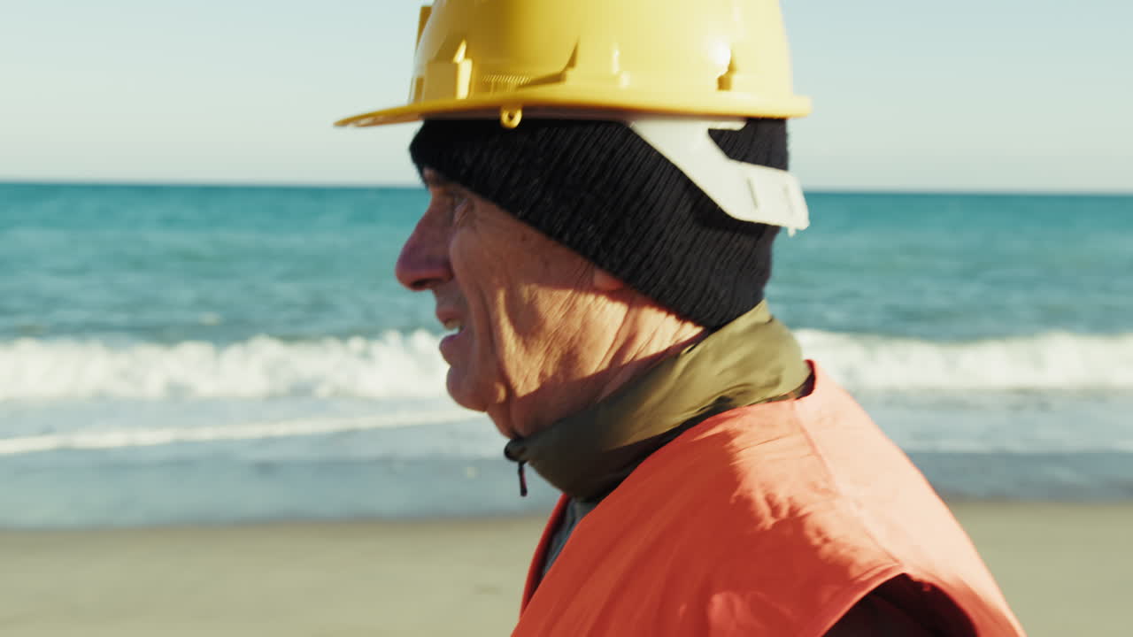 Construction Worker Walking by the Sea in the Morning