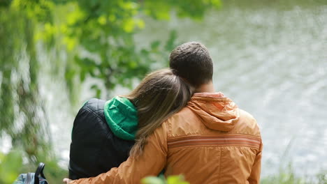 couple having a rest in park. romantic young couple in love having a rest together in nature