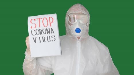 man wearing protective suit showing notepad with inscription