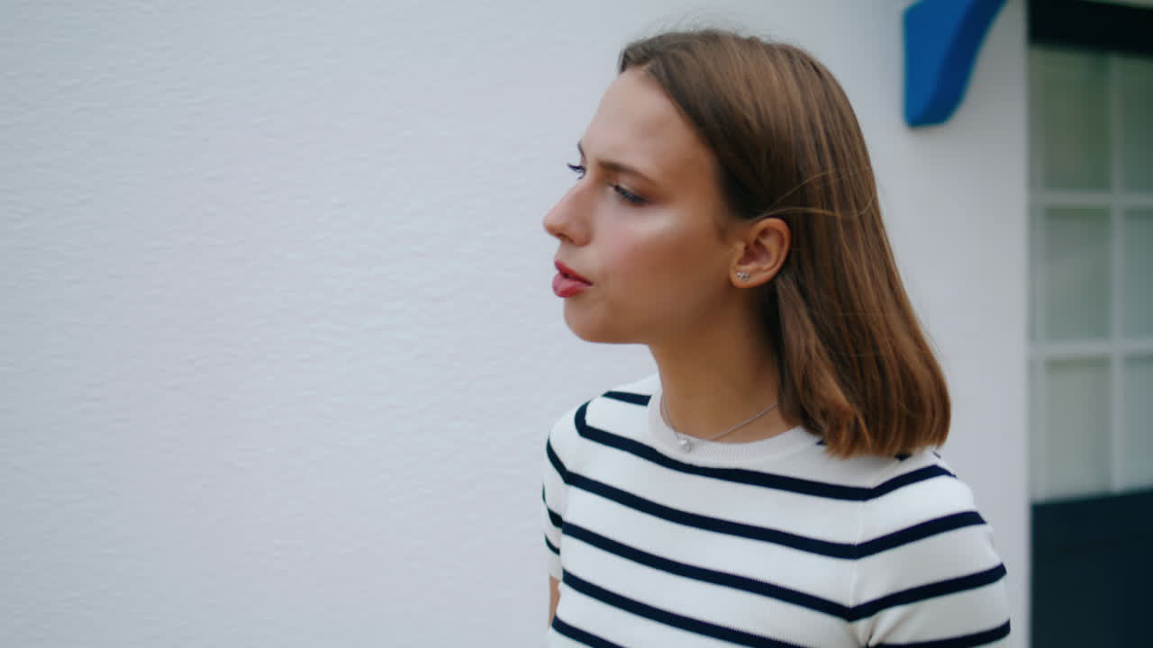 Pretty millennial walking town street on vacation closeup. Curious girl looking