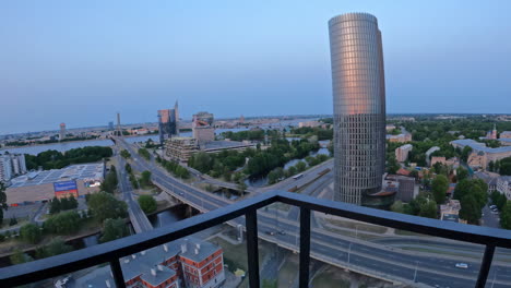 push in between railing and ceiling reveals road and town at blue hour, riga latvia