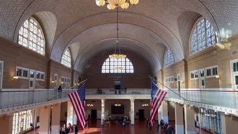 several tourists visit the hall of the former border post on ellis island