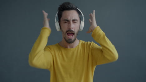 man dancing to music with headphones