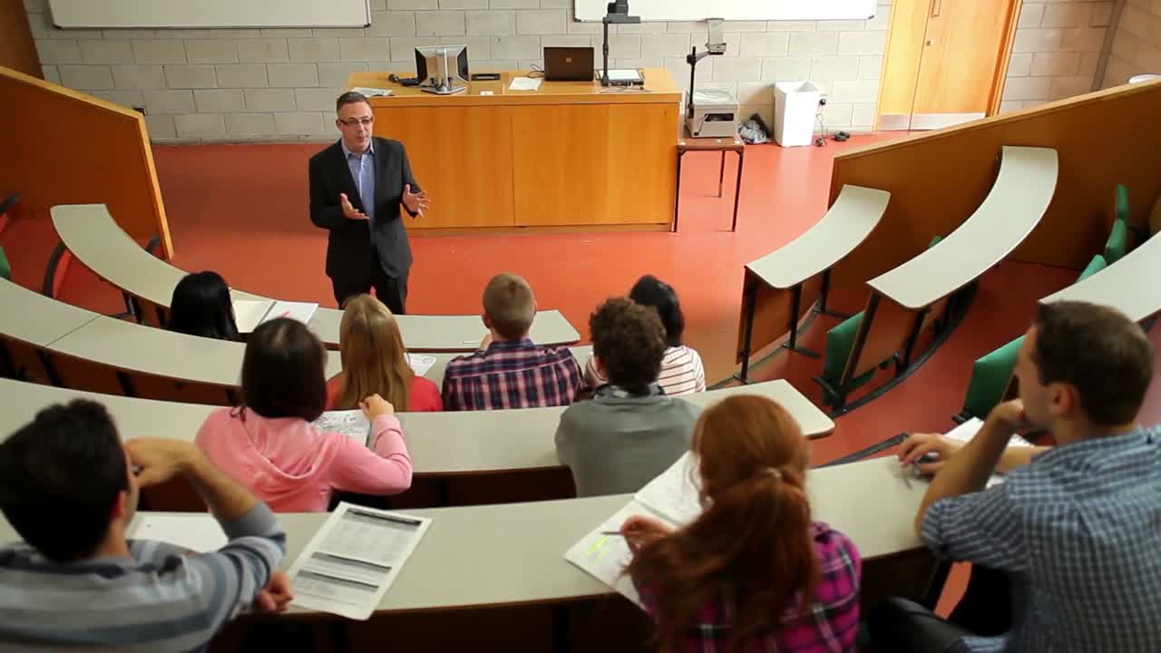 Lecturer speaking to his class in the lecture hall