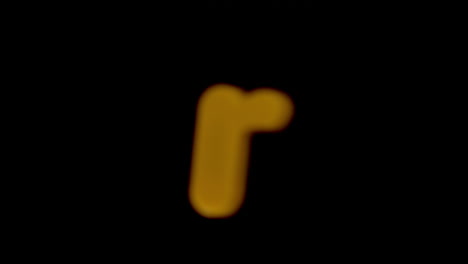 the letter r coming into focus on black background