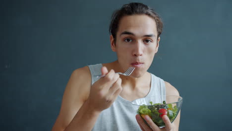 young man eating a salad