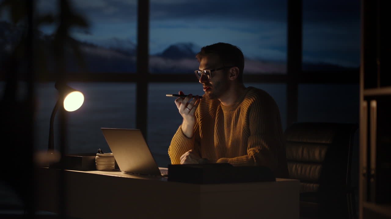 Portrait of Thoughtful Successful Businessman Working on Laptop Computer in His Big City Office. Digital Entrepreneur does Data Analysis for e-Commerce Strategy.
