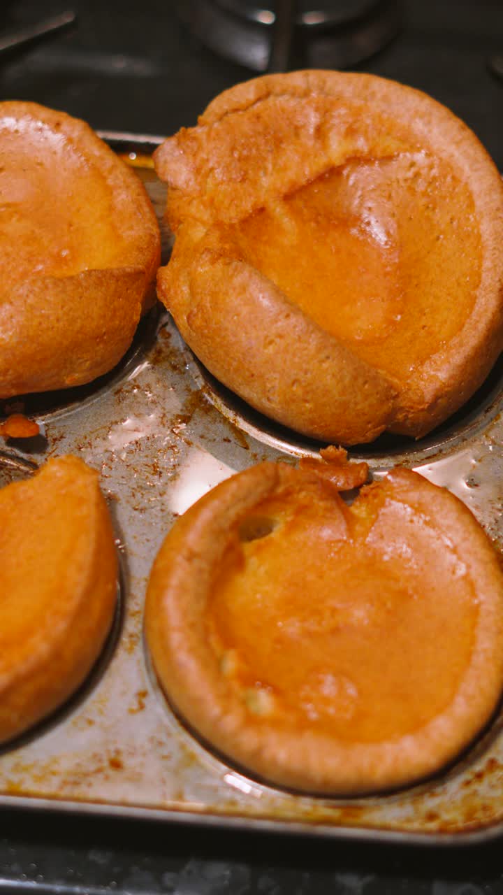 Vertical Video of Beautifully Risen Golden English Yorkshire Puddings Made Traditonally with Flour, Eggs, Milk Then Cooked in Oven to Perfection. Slow Motion Food Photography. British Cuisine.