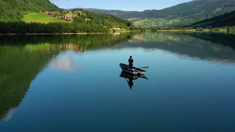 woman on the boat catches a fish on spinning in norway.