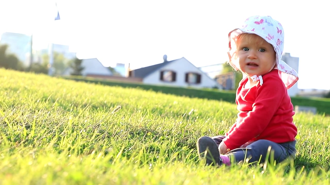 Baby krabbelt an einem sonnigen Tag auf dem Gras
