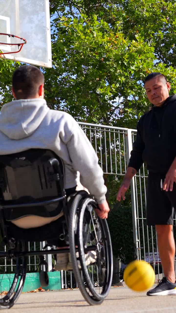 Man in Wheelchair Playing Basketball with Friend
