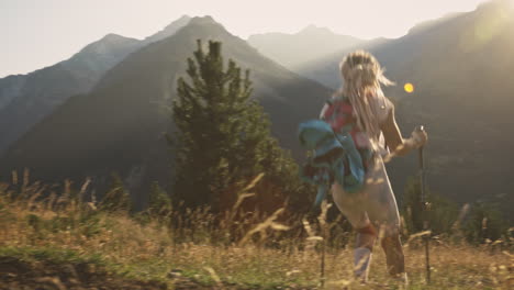 Blonde-woman-with-dreadlocks-hiking-fast-downhill,-Benasque,-Spain,-wide-shot