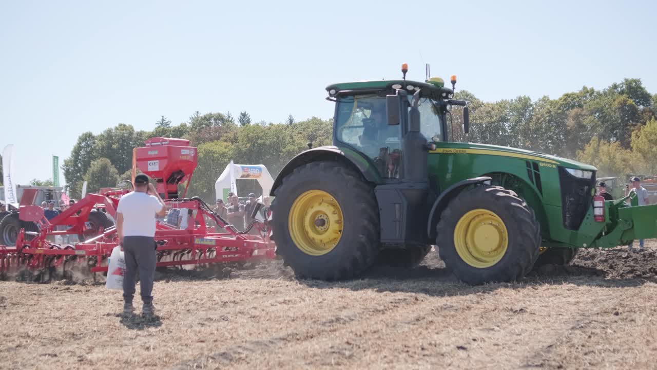Tractor plowing and seeding in the field