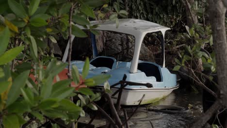 Un-Bote-De-Pedales-Recreativo-Amarrado-En-La-Orilla-Del-Río-Chanthaburi,-Tailandia