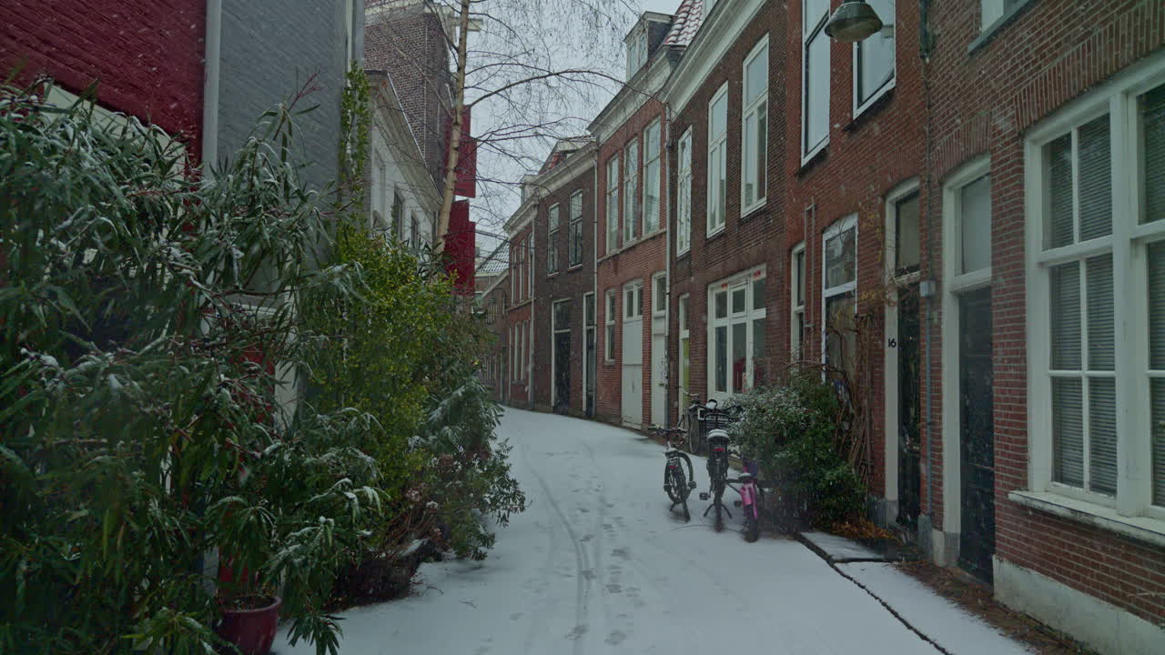 Snow snowfall in Europe European Dutch city town of Netherlands during the winter season with houses, streets and authentic North weather climate