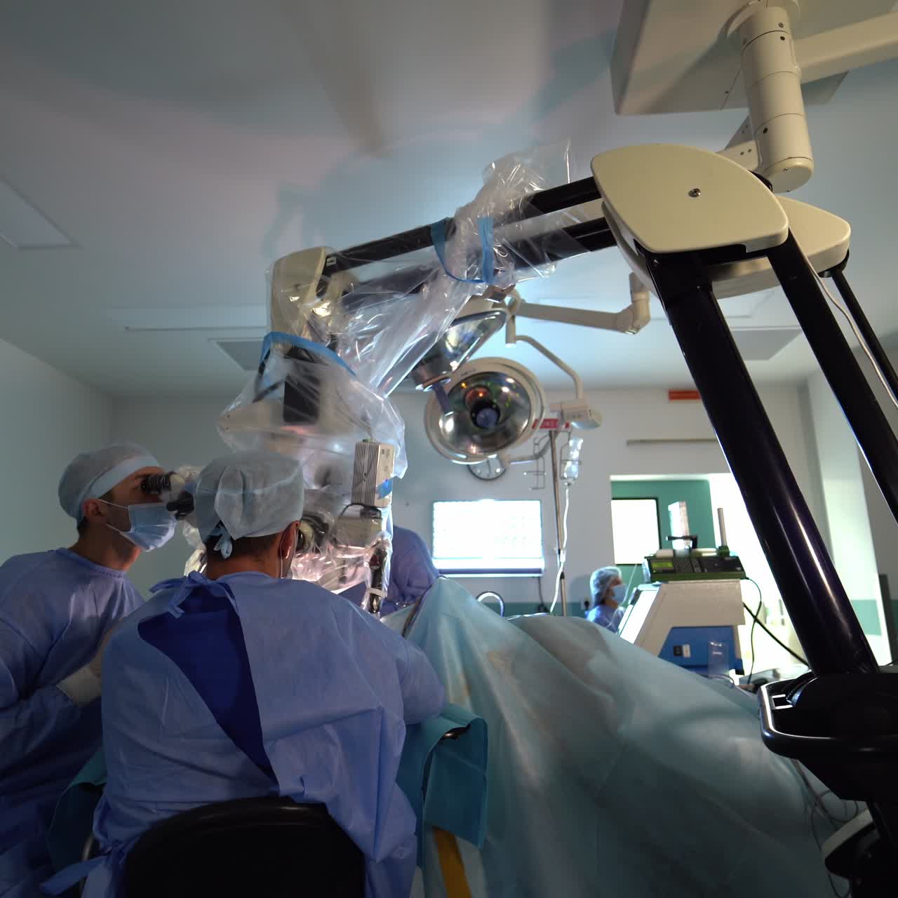 Medical specialists using instruments in operating room. Group of professional surgeons in uniform operating