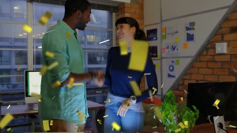 Animation-of-confetti-falling-over-diverse-business-partners-shaking-hands-and-discussing-in-office