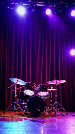 drum set on a stage with colorful stage lighting