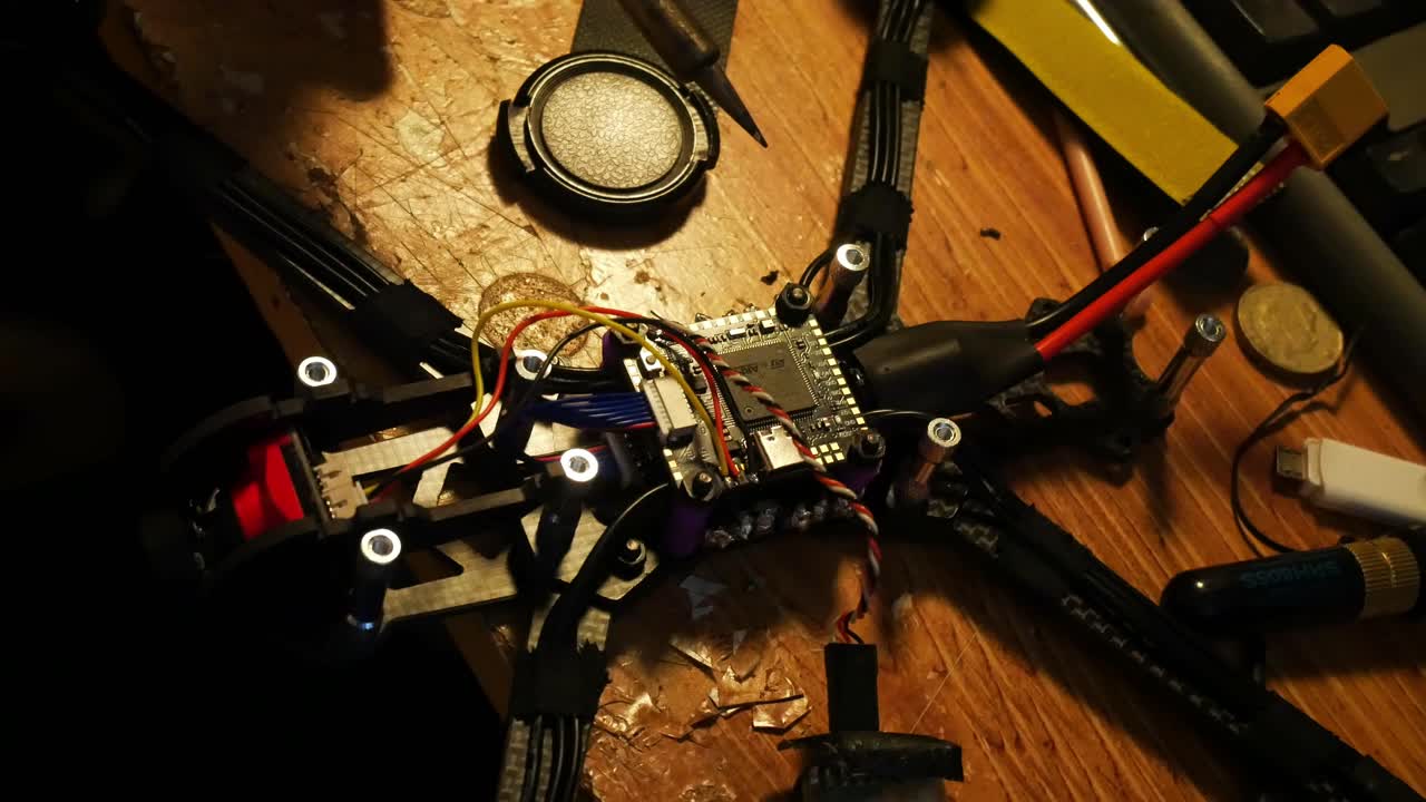 Close up preparing soldering wiring for FPV drone hobby build on the controller circuit board