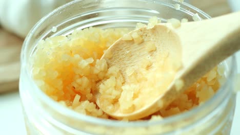 close up of minced garlic on a wooden spoon ,