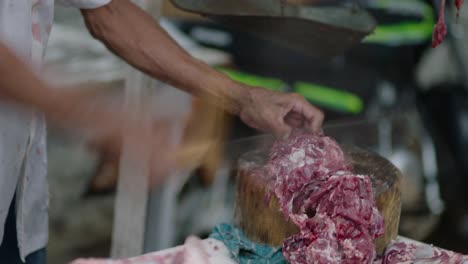 butcher cutting a piece of fresh meat