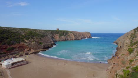 Flying-over-the-beautiful-beach-of-the-Sardinia-island-Cala-Domestica-and-seeing-its-famous-tower-on-the-horizon