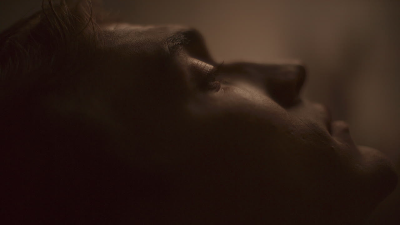 Close-Up of Young Contemplative Man Looking Upward in Deep Thought