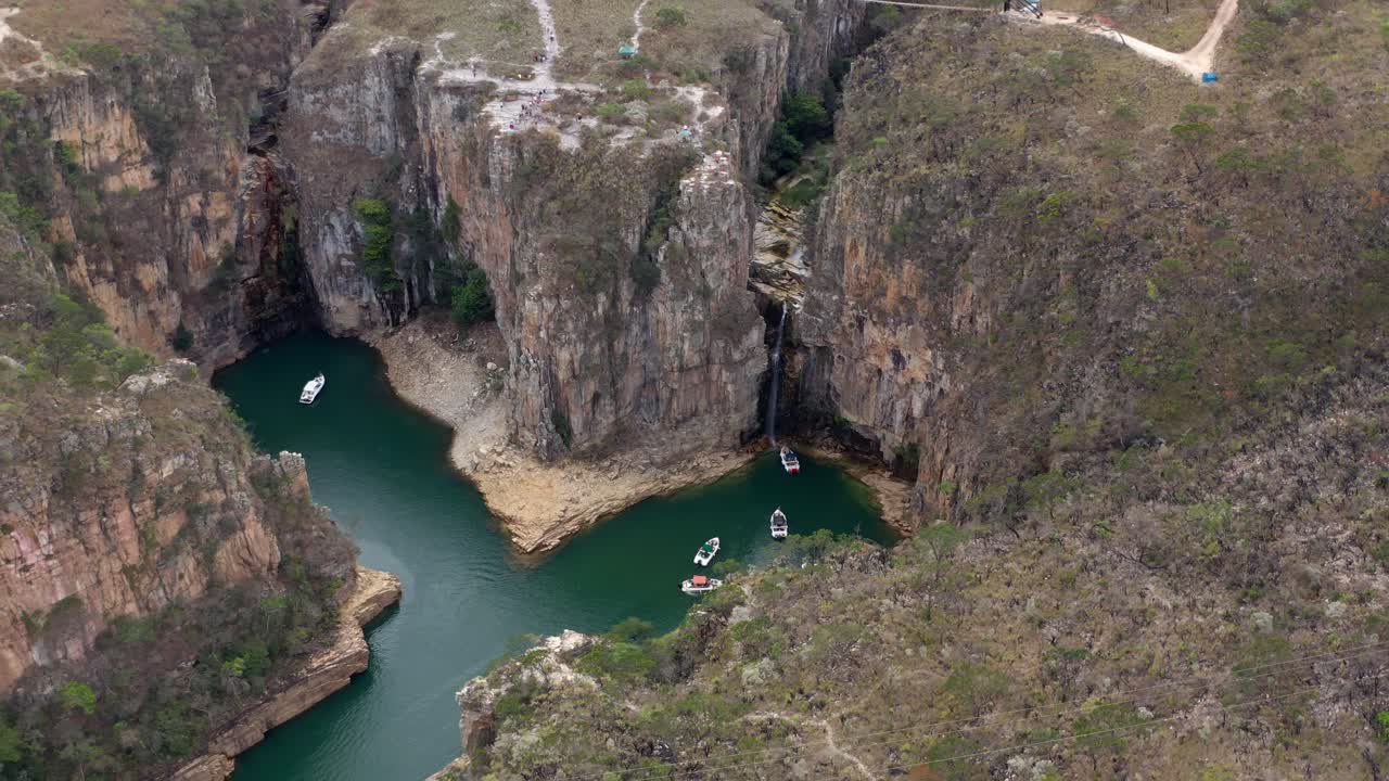 Stunning canyon lake with boats and a waterfall in Minas Gerais, Brazil
