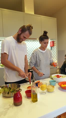 couple cooking together in kitchen