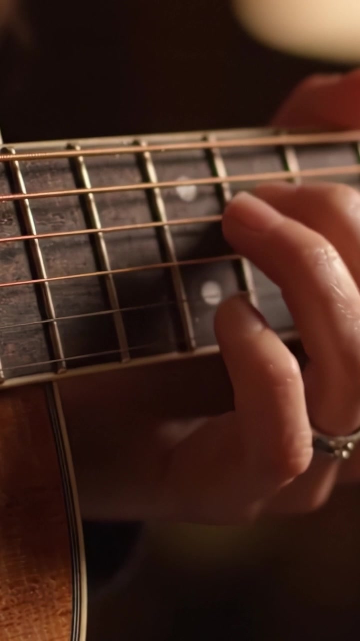 Captivating Close-up Frames of Fingerstyle Guitar Playing, Showcasing the Intricate Movement and Vivid Textures of the Instrument's Strings and Body.