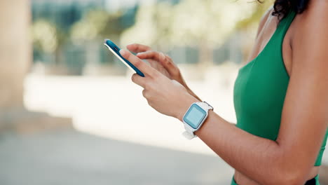 woman using smartphone and smartwatch outdoors