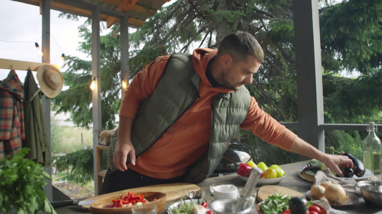 Culinary Blogger Cutting Eggplant on Outdoor Terrace