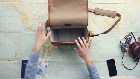 top view woman traveler packing travel gear hands planning holiday at vintage desk from above - red epic dragon