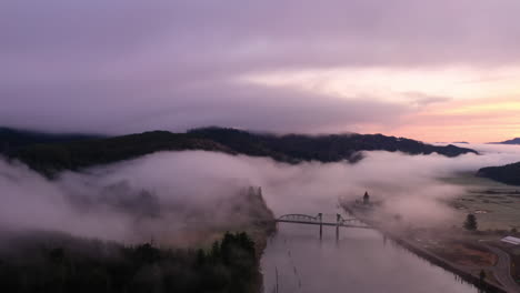 dramatic oregon sunrise over coos river and bridge