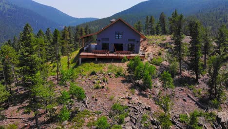 lonely isolated house cabin on vast alpine woodlands mountain hill peak