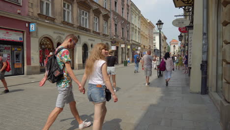 people walking in a city street with shops