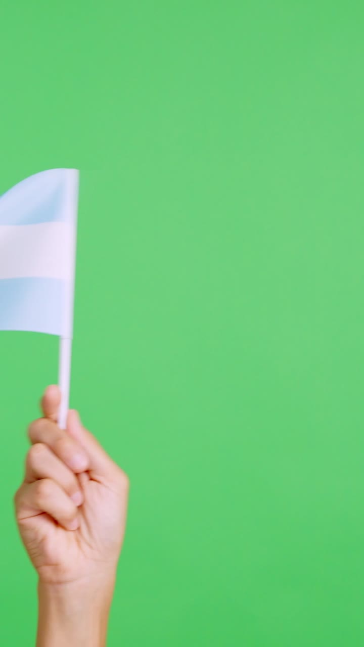 Hand waving a pennant of a argentine national flag